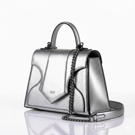 Hand bag The Vesta This bag is a symphony of feminine power and masculine structure. Its body is inspired by the delicate curve of a woman’s waist, while its overall silhouette evokes the look of powerful, daring shoulders. This tension culminates in the flap, whic